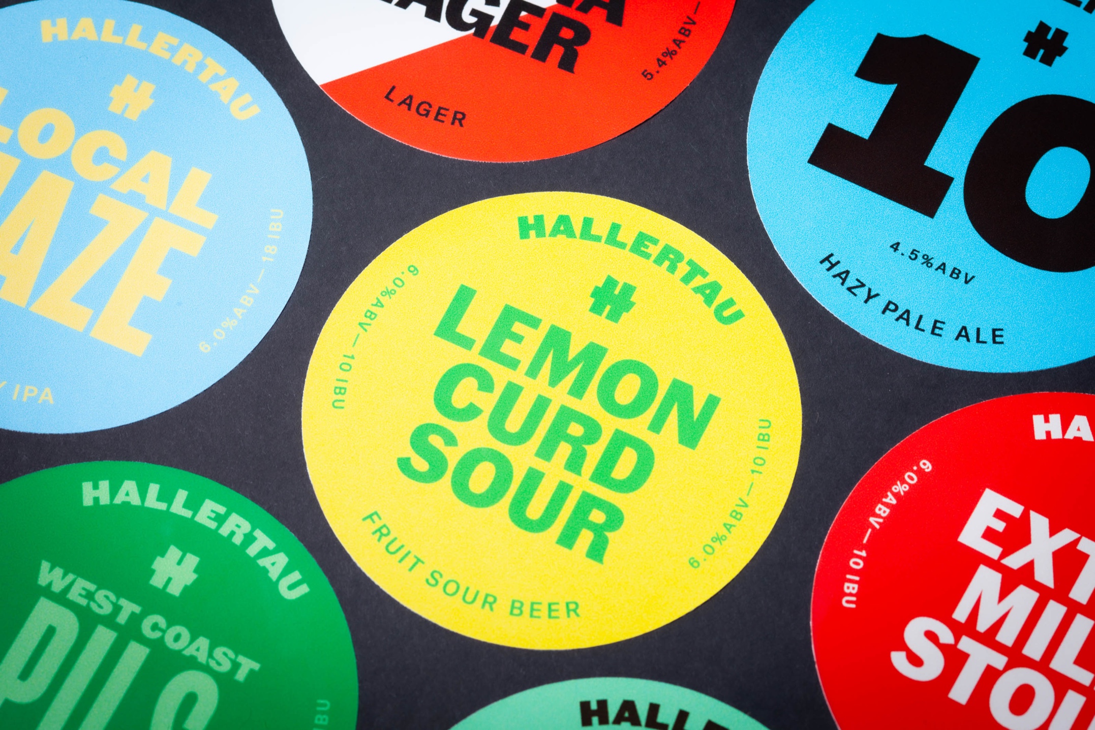 Custom printed tap badges for Hallertau Brewery, removable vinyl with bold colour graphics.