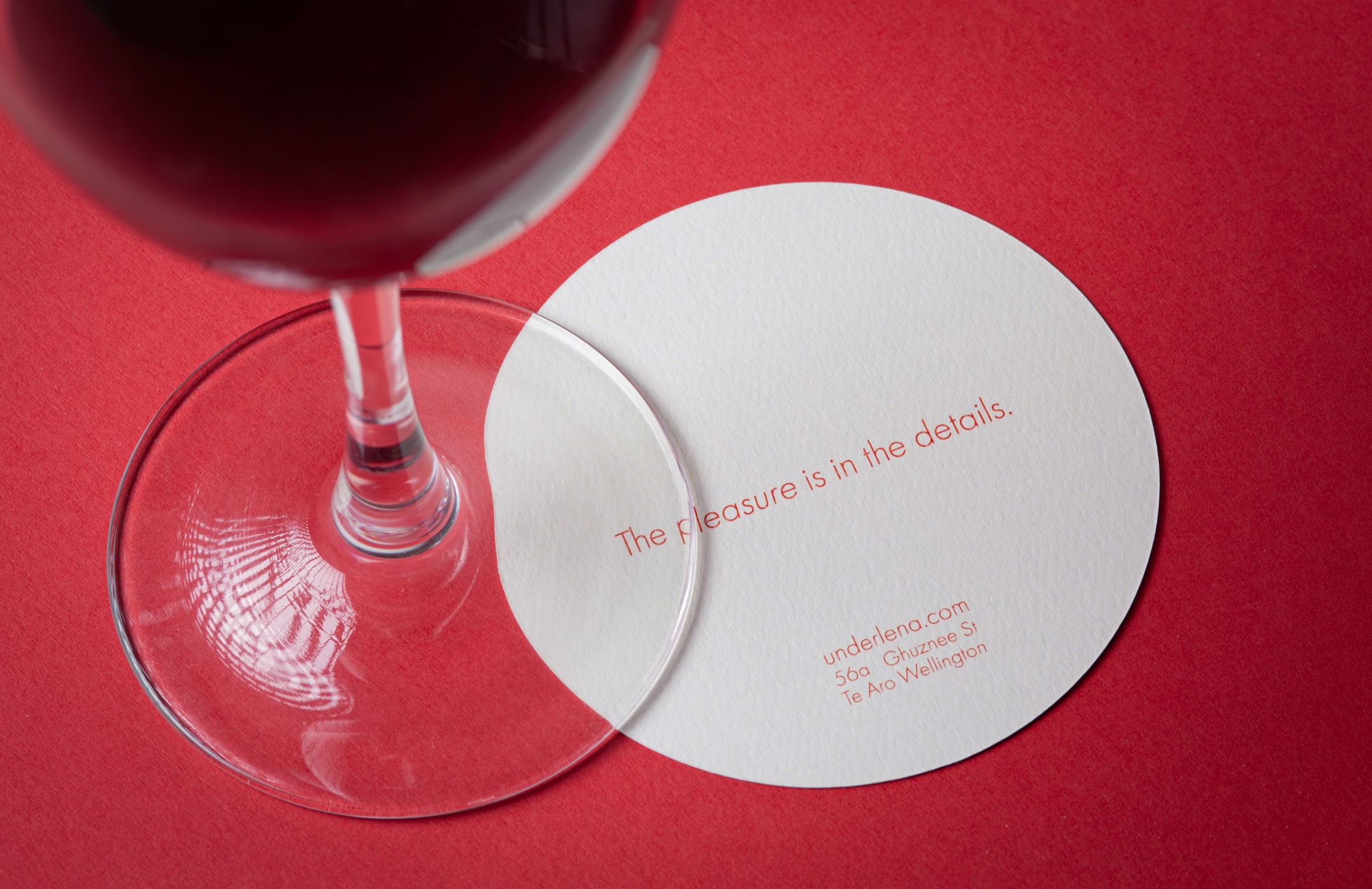 Stack of premium printed coasters on felt-textured 298gsm stock, showcasing the precise die-cut shapes and refined finish